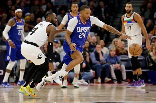 Clippers forward Norman Powell, center, steals the ball from Minnesota...