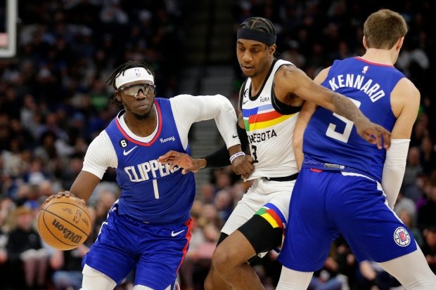 Clippers guard Reggie Jackson drives around Minnesota Timberwolves forward Jaden...