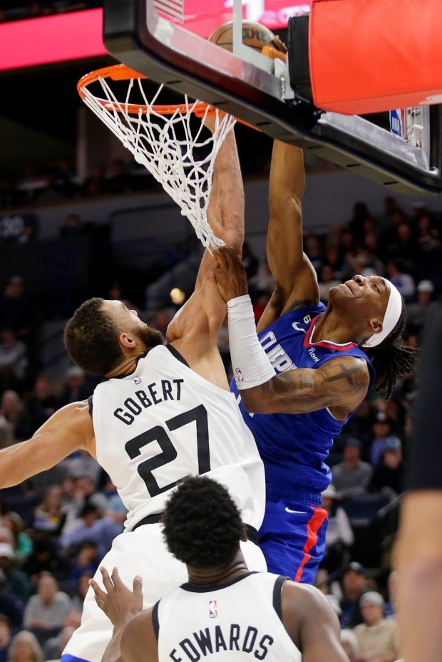 Minnesota Timberwolves center Rudy Gobert, left, blocks a dunk attempt...