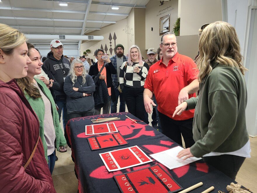 people stand around a table talking