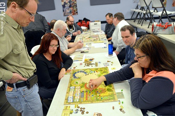 Gamers play a round of Tzolk'in: The Mayan Calendar at Millennium Games. - PHOTO BY MATT DETURCK